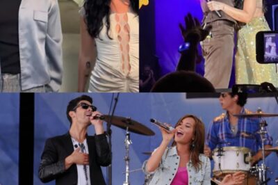 One second it was quiet, the next the arena erupted — Demi Lovato emerges from the shadows, commanding the crowd with Camp Rock classics as if no time had passed.