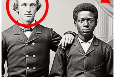 Why were experts pale when enlarging this portrait of two friends from 1870? The afternoon light filtered through the tall windows of the Historical Preservation Society in Charleston, South Carolina, casting long shadows across Dr.  Rebecca Martinez’s cluttered desk.  She had been cataloging old photographs for nearly 3 weeks, her eyes tired from squinting at faded faces and cracked glass plates.  Most were routine, families posed stiffly in their Sunday best, children with blank expressions, soldiers frozen in time before unknown fates.  But this one was different.  Rebecca held the Dger type up to the light, her breath catching slightly.  Two young men, perhaps in their early 20s, stood side by side in what appeared to be a photography studio.  The backdrop was painted with classical columns and draped fabric, typical of the era.