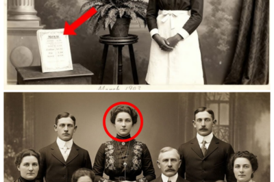 Historians review a 1911 portrait and discover one family member was never there.  Dr.Amanda Foster adjusted her reading glasses as she examined the sepiaone photograph that had arrived at the Boston Historical Society that morning.  The donor, Mrs.Catherine Mills, had explained that it was a family portrait from 1911, discovered in her late grandmother’s attic.  What made it particularly interesting was the note attached.  The Henley family, Boston, Massachusetts, 1911.  Five generations together.  The photograph showed seven people arranged in the formal style typical of the early 1900s.  An elderly patriarch sat in the center, surrounded by what appeared to be his descendants, middle-aged adults, younger couples, and children.  Their clothing was well tailored, suggesting a family of means, and the studio setting indicated this had been a significant occasion worth commemorating professionally.  Amanda had been documenting Boston family histories for over 15 years, and something about this particular image nagged at her.  The composition was perfect, almost too perfect.