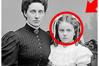 This 1897 Studio Portrait of a Mother and Daughter Looks Serene — Until You See Their Eyes, and Suddenly the Calm Turns to Ice 👁️ — At first it’s pure Victorian sweetness, lace collars, folded hands, the kind of tender family keepsake you’d hang over a fireplace, but the moment experts enhanced the image, those eyes stopped looking gentle and started looking watchful, almost pleading, as if both subjects knew something terrible the camera accidentally preserved forever 👇