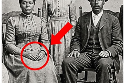 It Was Just a Studio Photo — Until Experts Zoomed In and Saw What the Parents Were Hiding in Their Hands, and the Room Went Dead Silent 📸 — At first it looked like another stiff, sepia family portrait, the kind you pass without a second thought, but when historians enhanced the image and spotted the tiny, deliberate objects clutched tight against their palms, the smiles suddenly felt forced, the pose suspicious, and the entire photograph transformed from wholesome keepsake into something deeply unsettling 👇
